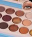 Close-up of a 12-color eyeshadow palette with shimmer and matte shades, and a zoomed-in image of a beautifully made eye with eyeshadow in the upper corner.
