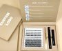 Luxurious cluster lashes kit with application tools and custom logo, presented in an elegant beige box.