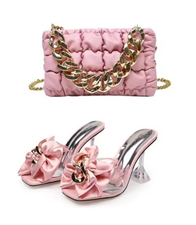 Luxury pink puffy handbag with gold chain strap and matching bow heels with clear heel