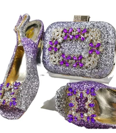 A stunning purple glitter shoe and clutch set adorned with sparkling purple and clear stones, perfect for formal occasions.