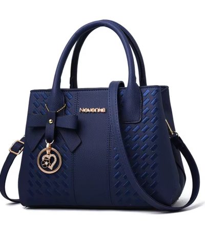 A luxurious navy blue woven leather handbag with gold accents and a heart-shaped charm, perfect for adding a touch of sophistication to any outfit.