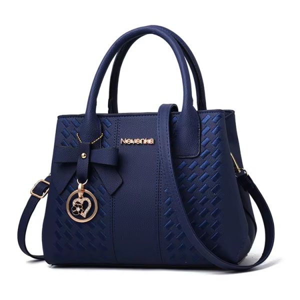 A luxurious navy blue woven leather handbag with gold accents and a heart-shaped charm, perfect for adding a touch of sophistication to any outfit.