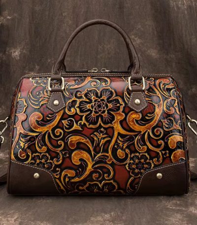 A luxurious brown leather handbag with intricate floral design, perfect for adding a touch of sophistication to any outfit.