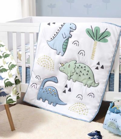 A beautifully designed dino-themed comforter set with soft quilt and crib bedding, perfect for a luxurious baby's nursery.