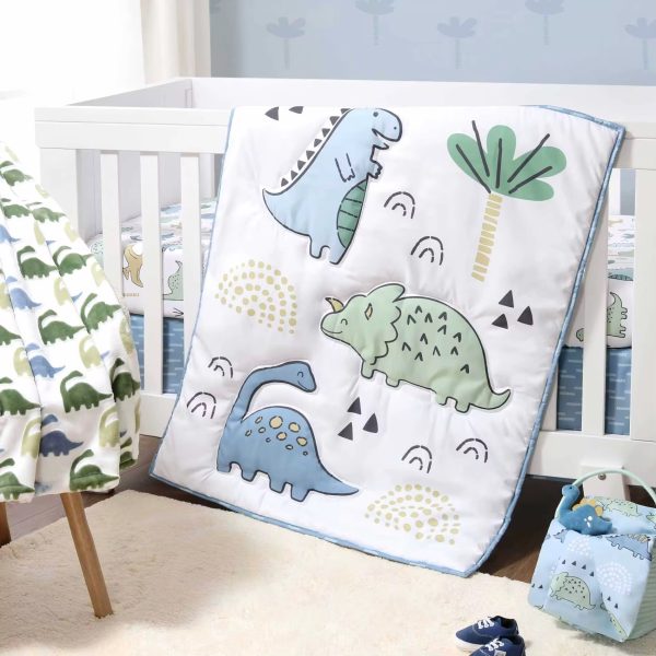 A beautifully designed dino-themed comforter set with soft quilt and crib bedding, perfect for a luxurious baby's nursery.