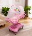 A pink baby crib with mosquito net and mobile in a cozy living room, perfect for a comfortable and safe sleeping space for your baby.